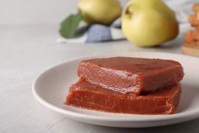 Photo of Delicious quince paste on white table, closeup