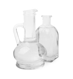 Vinegar in glass jug and bottle isolated on white