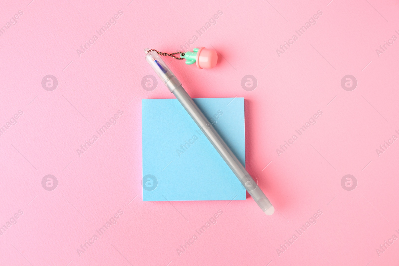 Photo of Colorful paper notes with erasable pen on pink background, top view