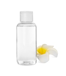 Photo of Bottle of micellar cleansing water and flower on white background