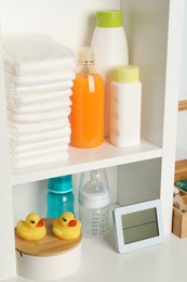 Photo of Toys and baby accessories on white rack