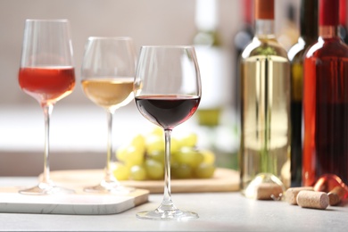 Photo of Different glasses with wine served on table