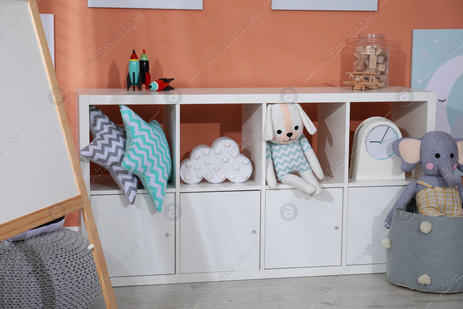 Photo of Cute child's room interior with toys and modern furniture