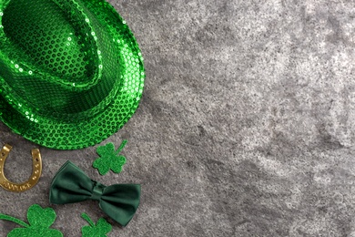 Leprechaun's hat and St. Patrick's day decor on grey stone background, flat lay. Space for text
