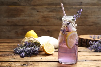 Photo of Fresh delicious lemonade with lavender on wooden table