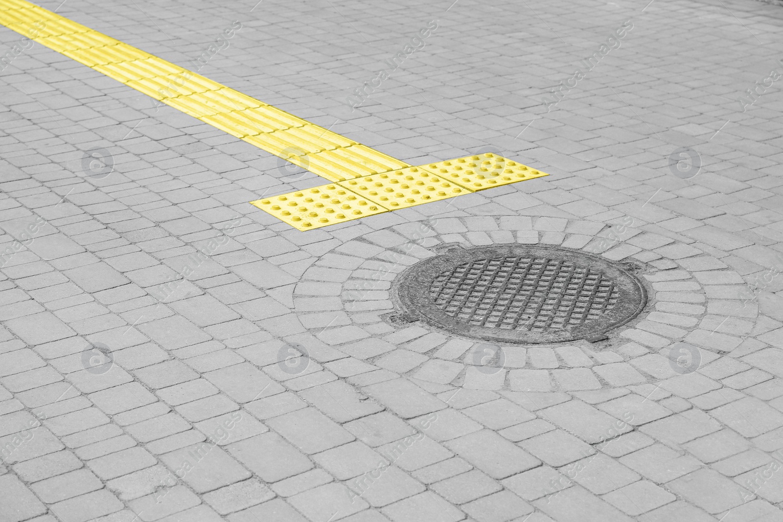 Photo of Metal sewer hatch on street tiles outdoors, space for text