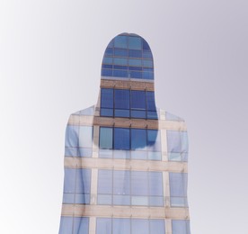 Image of Double exposure of businesswoman and office building