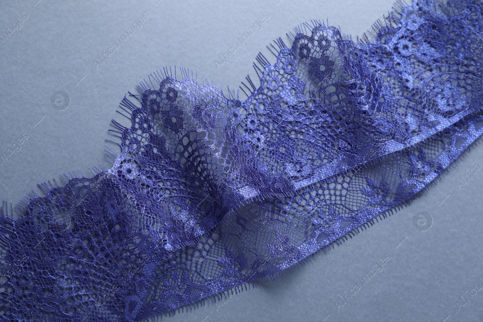 Photo of Beautiful lace on light blue background, top view