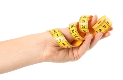 Woman holding yellow measuring tape on white background, closeup