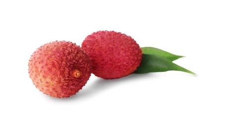 Fresh ripe lychees with green leaves on white background