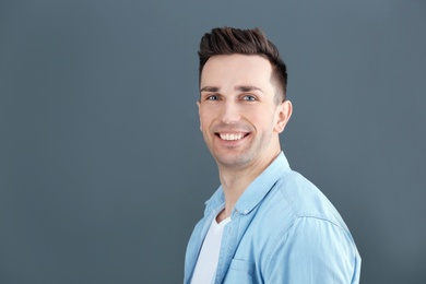 Photo of Charming young man on grey background