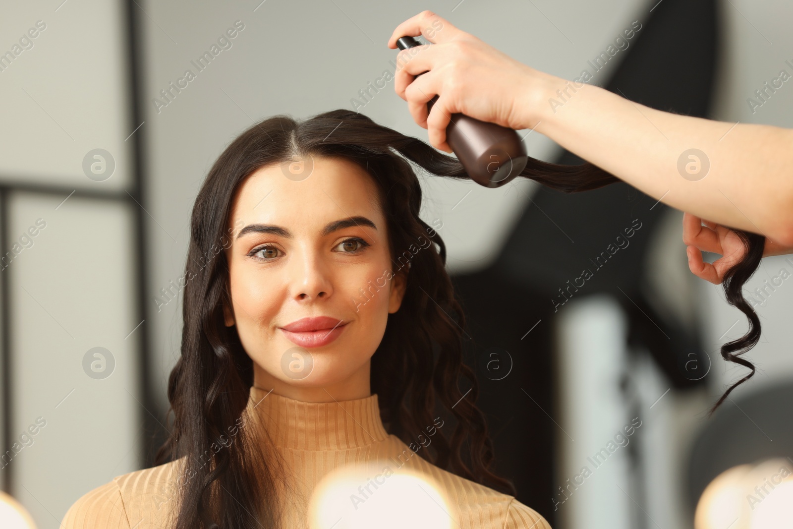 Photo of Hair styling. Professional hairdresser working with client in salon, closeup