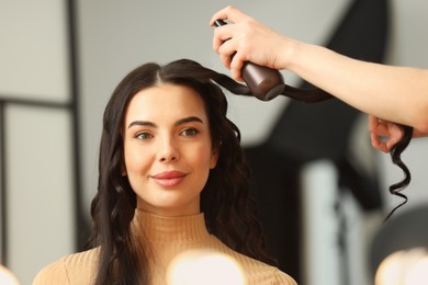 Photo of Hair styling. Professional hairdresser working with client in salon, closeup