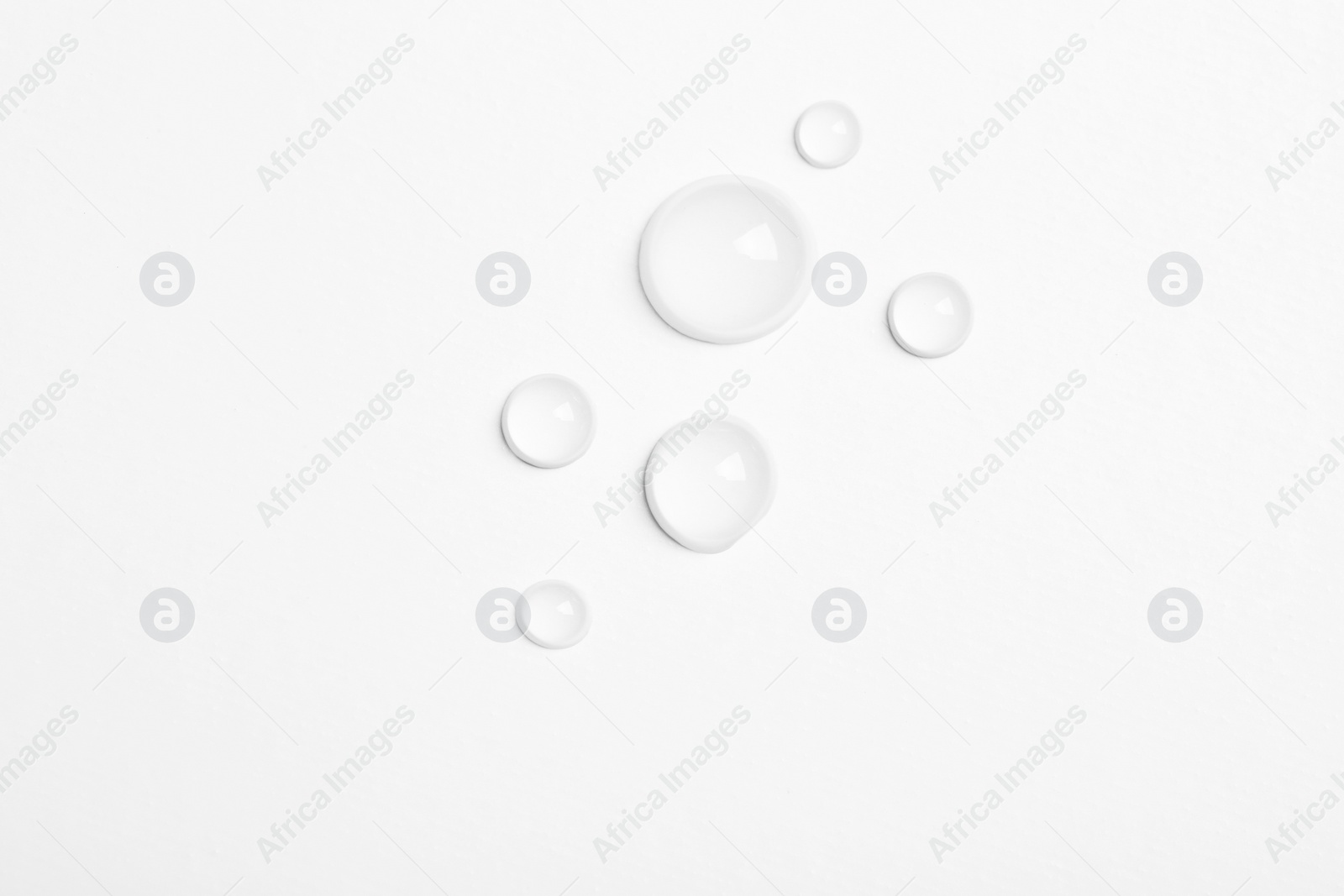 Photo of Water drops on white background, top view