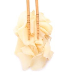 Chopsticks with pickled ginger on white background, top view