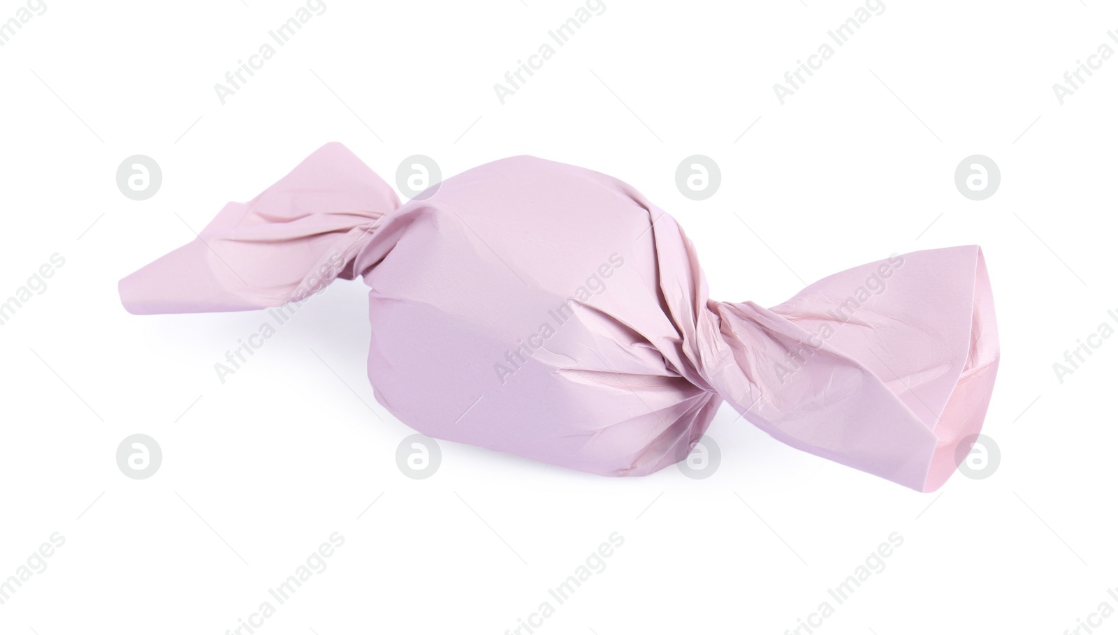 Photo of Tasty candy in pink wrapper isolated on white