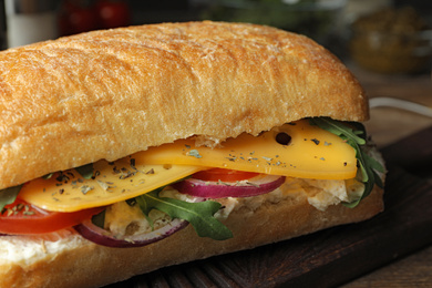 Delicious sandwich with fresh vegetables and cheese, closeup view