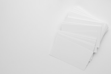 Photo of Blank business cards on white background, top view. Space for text