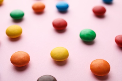 Photo of Tasty glazed candies on color background, closeup