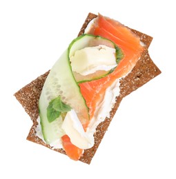 Photo of Tasty rye crispbreads with salmon, cream cheese and cucumber isolated on white, top view