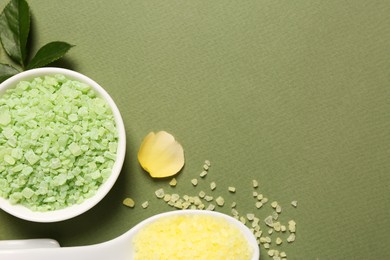 Photo of Bowl and scoop with sea salt, rose petal on olive background, flat lay. Space for text