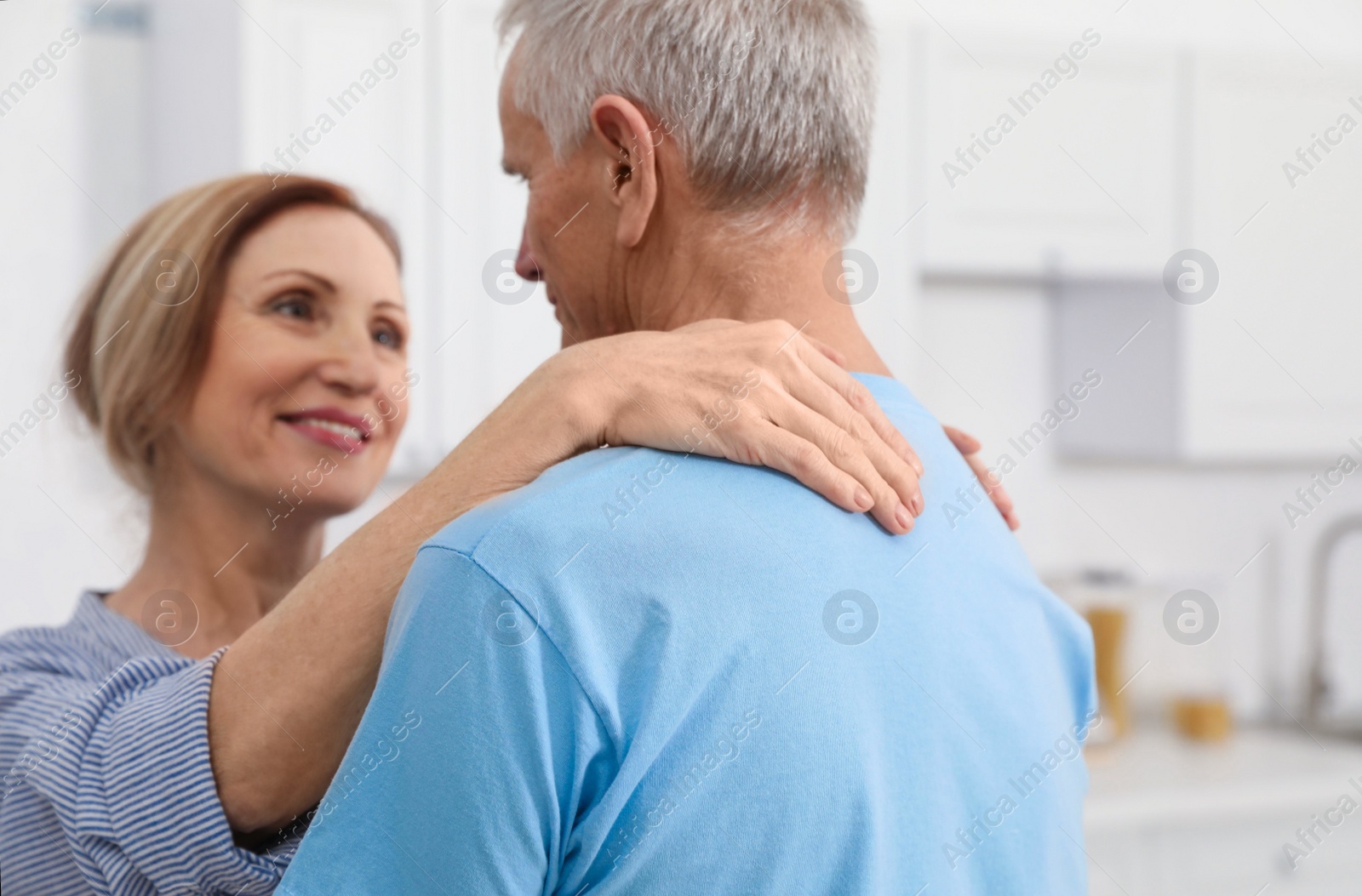 Photo of Happy senior couple dancing together at home, closeup