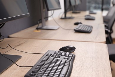Photo of Many modern computers in open space office, closeup