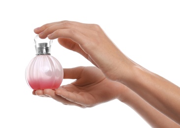 Young woman with perfume bottle on white background, closeup