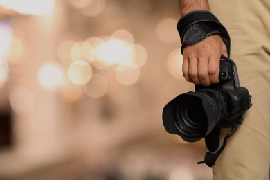 Image of Professional photographer with modern camera and blurred background, space for text