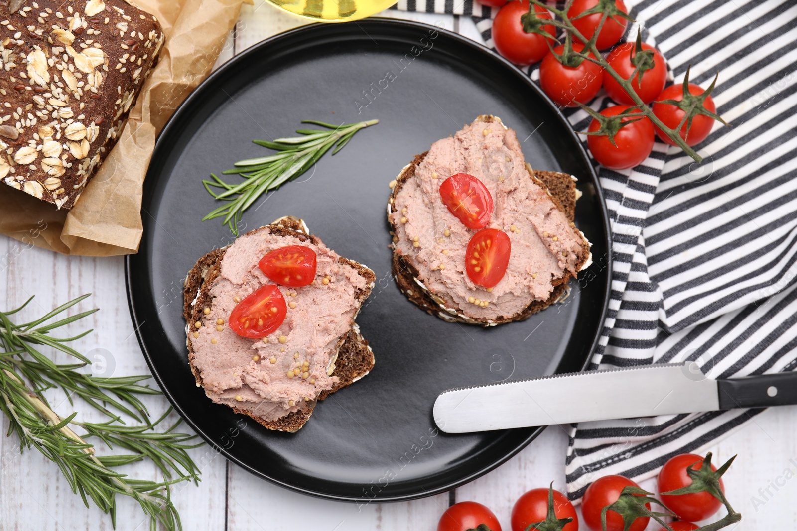 Photo of Delicious liverwurst sandwiches served on white wooden table, flat lay