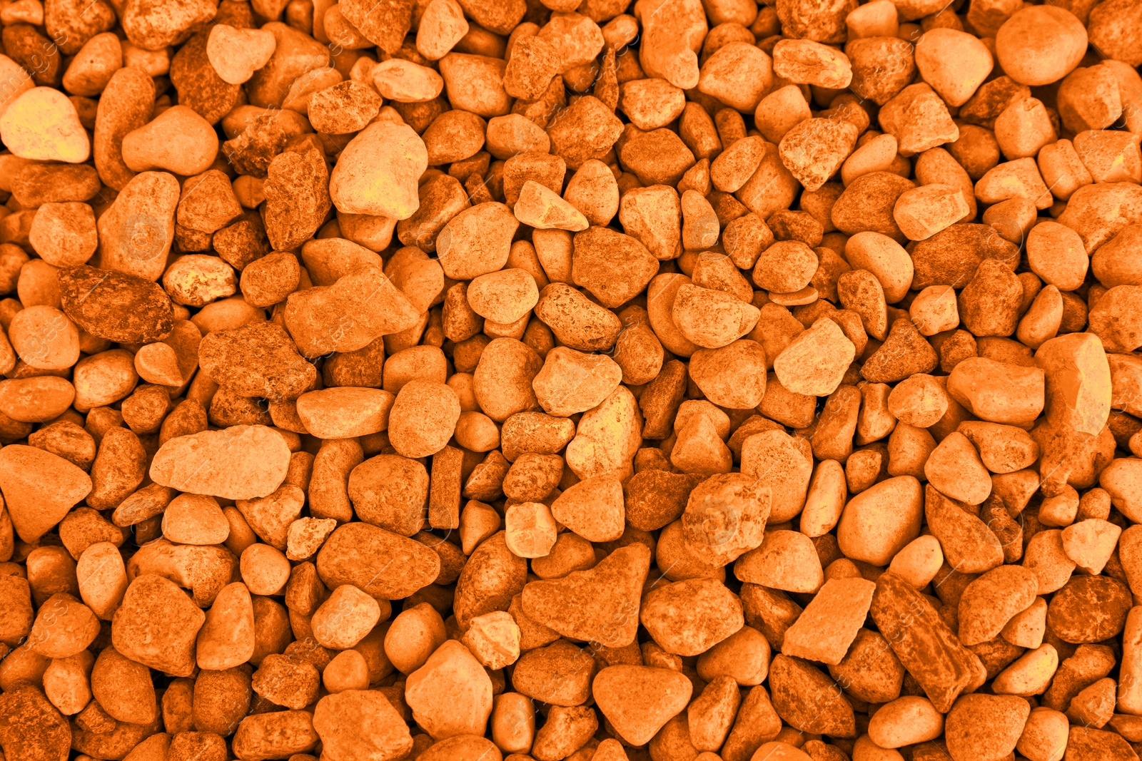 Image of Pile of stones as background, top view. Toned in orange