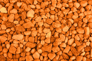 Image of Pile of stones as background, top view. Toned in orange