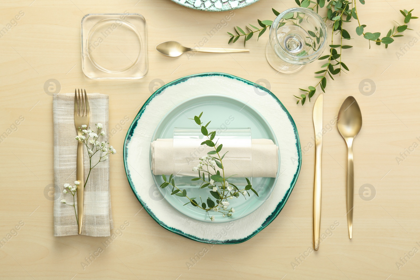 Photo of Elegant table setting with flowers and leaves, flat lay