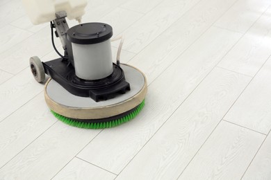 Photo of Modern polishing machine on parquet floor. Space for text