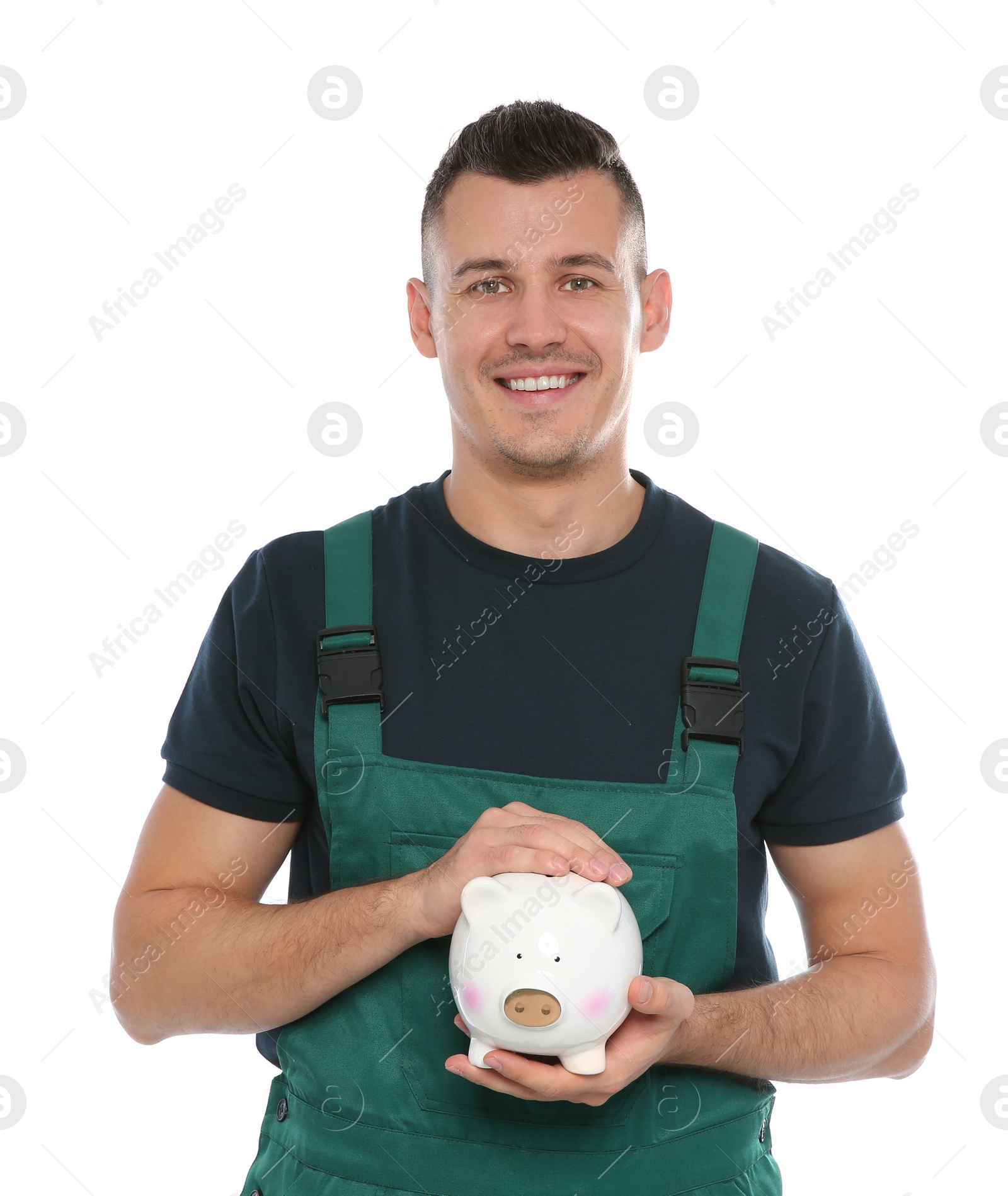 Photo of Portrait of male worker in uniform with piggy bank on white background