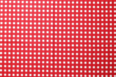 Red checkered tablecloth as background, top view