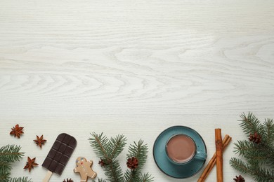 Delicious hot chocolate and Christmas decor on white wooden table, flat lay. Space for text