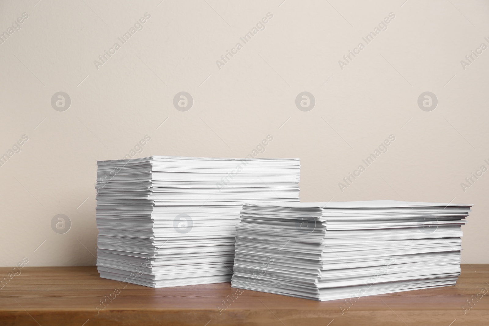 Photo of Stacks of paper sheets on wooden table