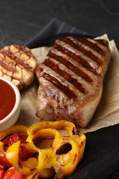 Photo of Delicious grilled beef steak with vegetables on table, closeup