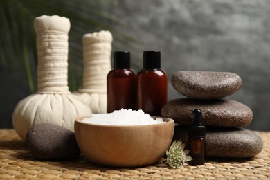 Photo of Beautiful spa composition with bath salt on wicker mat