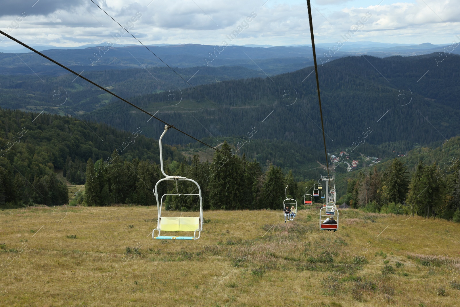 Photo of Ski lift and green trees at mountain resort