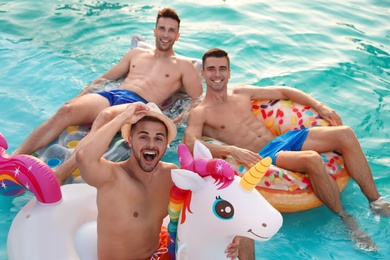 Photo of Happy young friends relaxing in swimming pool