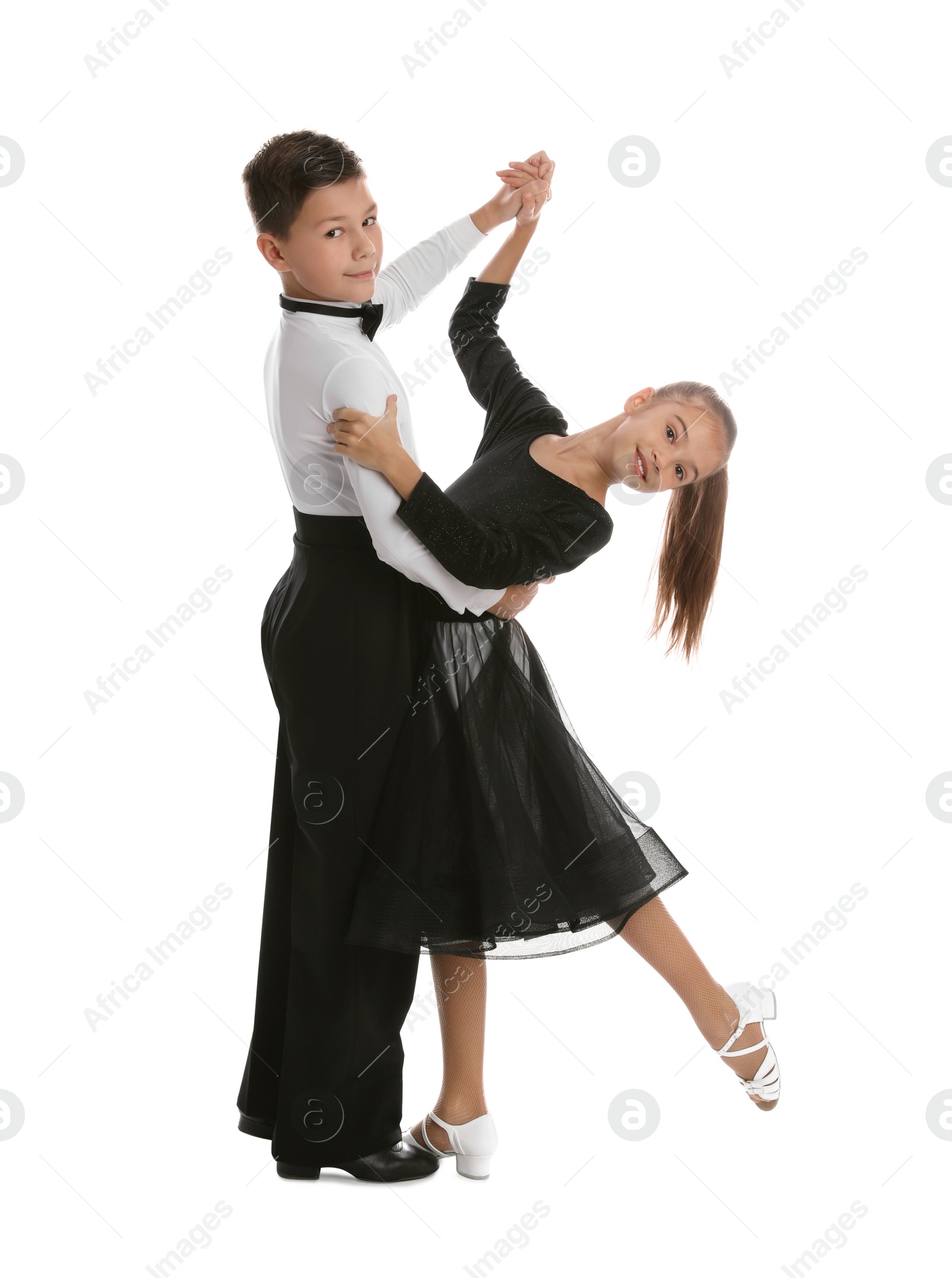 Photo of Beautifully dressed couple of kids dancing on white background