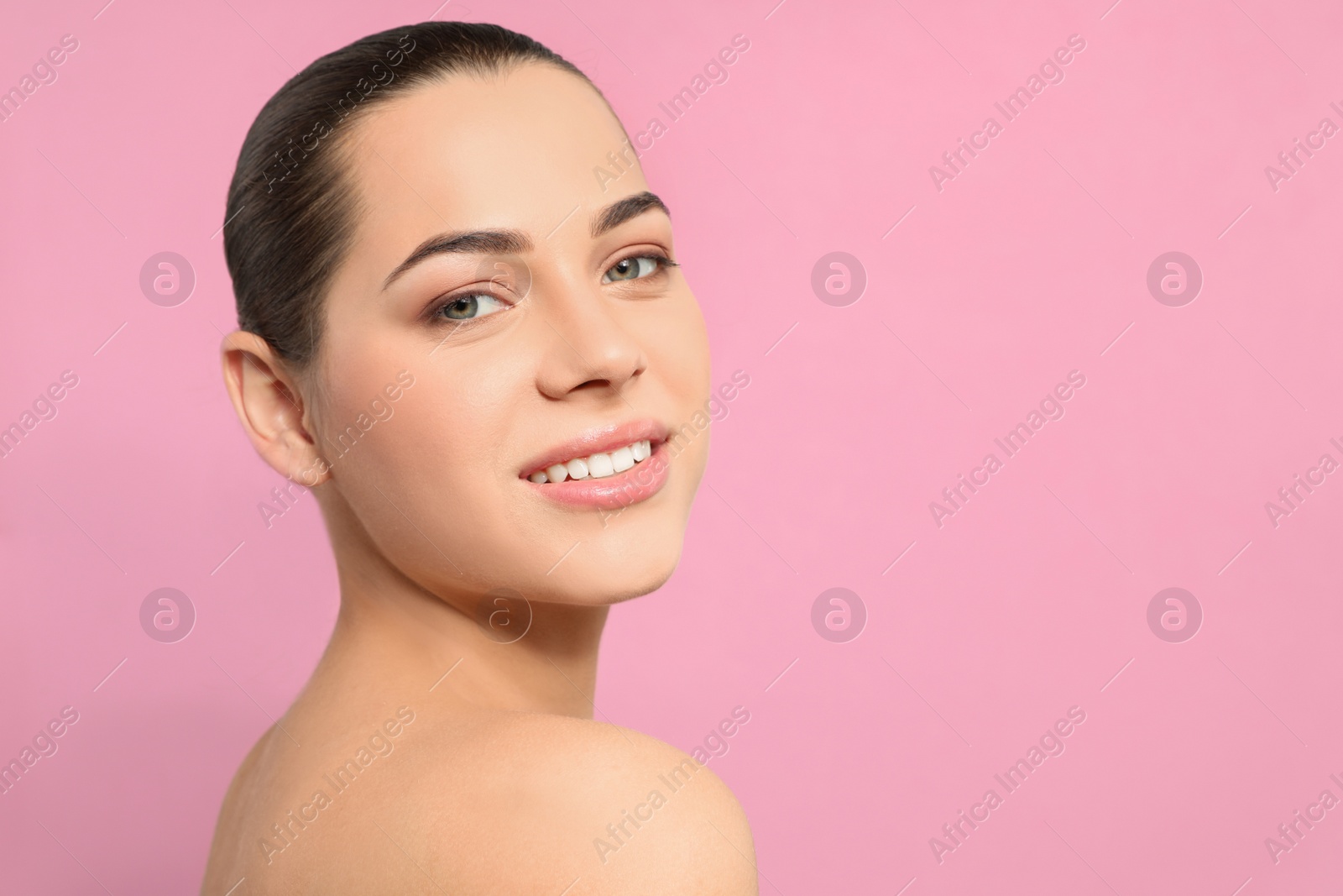 Photo of Portrait of young woman with beautiful face and natural makeup on color background, space for text