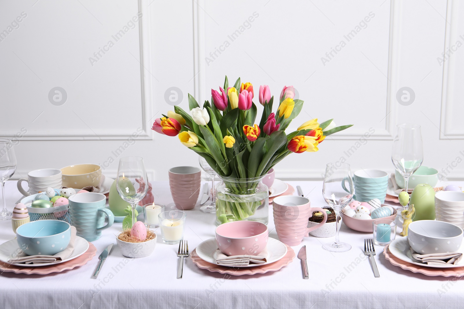 Photo of Festive table setting with beautiful flowers. Easter celebration