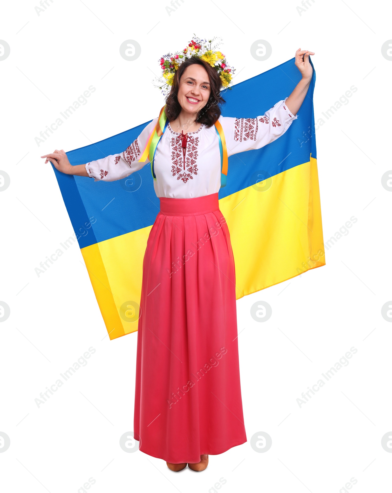 Photo of Happy woman in national clothes with flag of Ukraine on white background