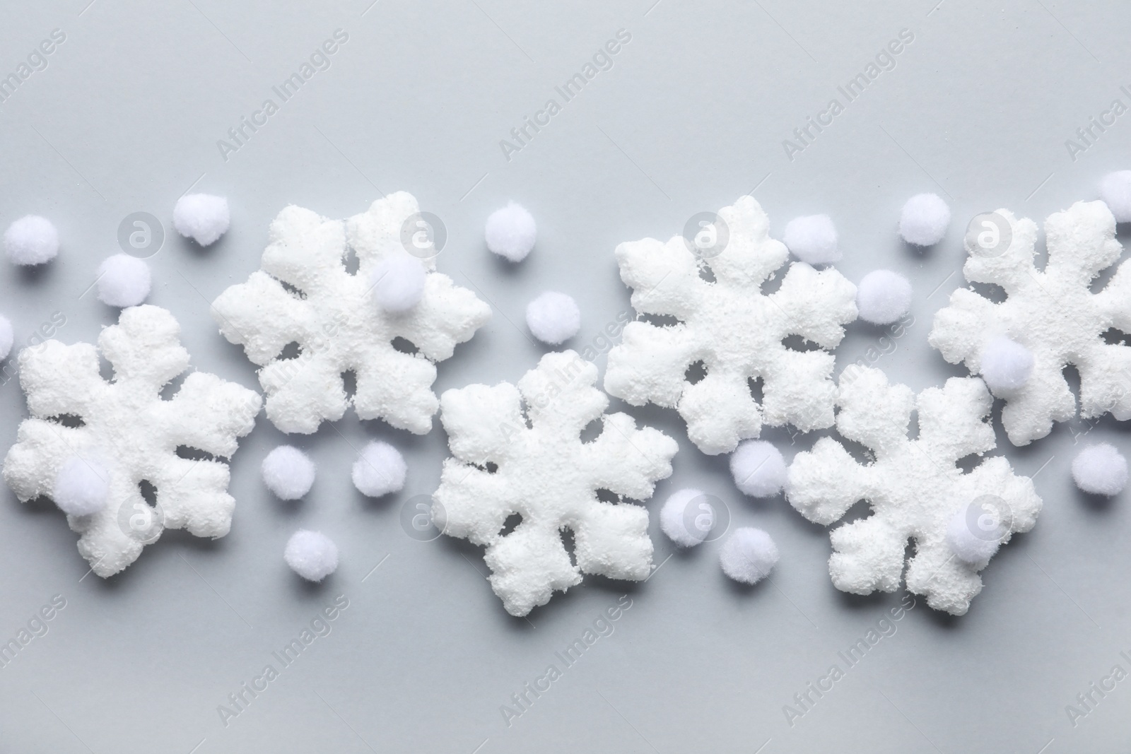 Photo of Beautiful snowflakes and decorative balls on white background, flat lay