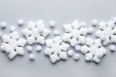 Beautiful snowflakes and decorative balls on white background, flat lay