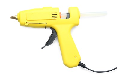 Photo of yellow glue gun with stick isolated on white, top view