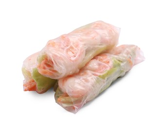 Photo of Tasty spring rolls with shrimps, carrot and lettuce on white background